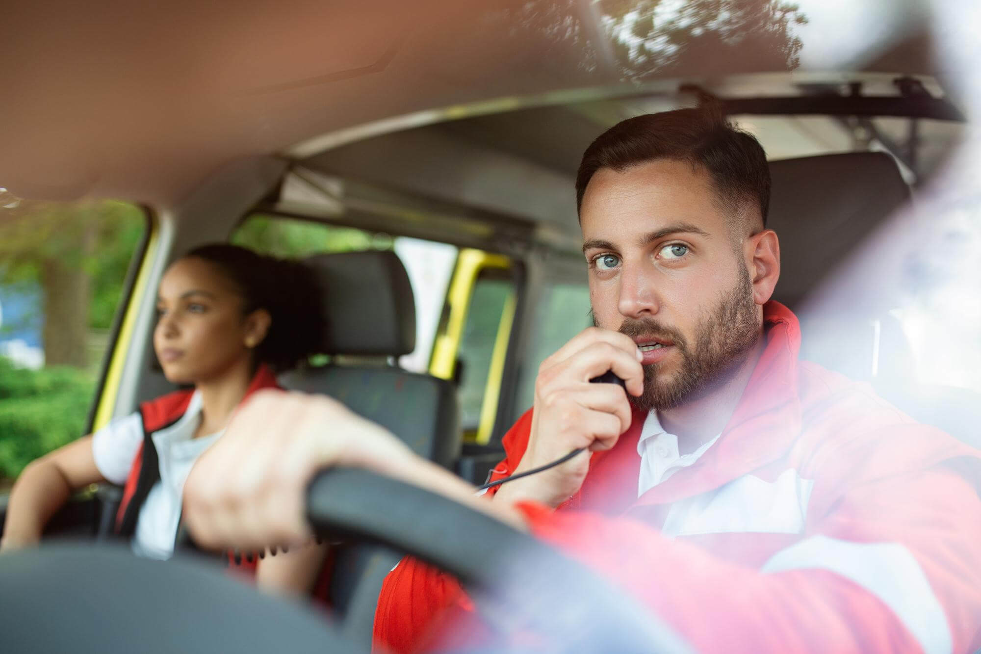 urgent-situation-two-young-paramedics-ambulance-male-caucasian-paramedic-driving-talking-radio (1)