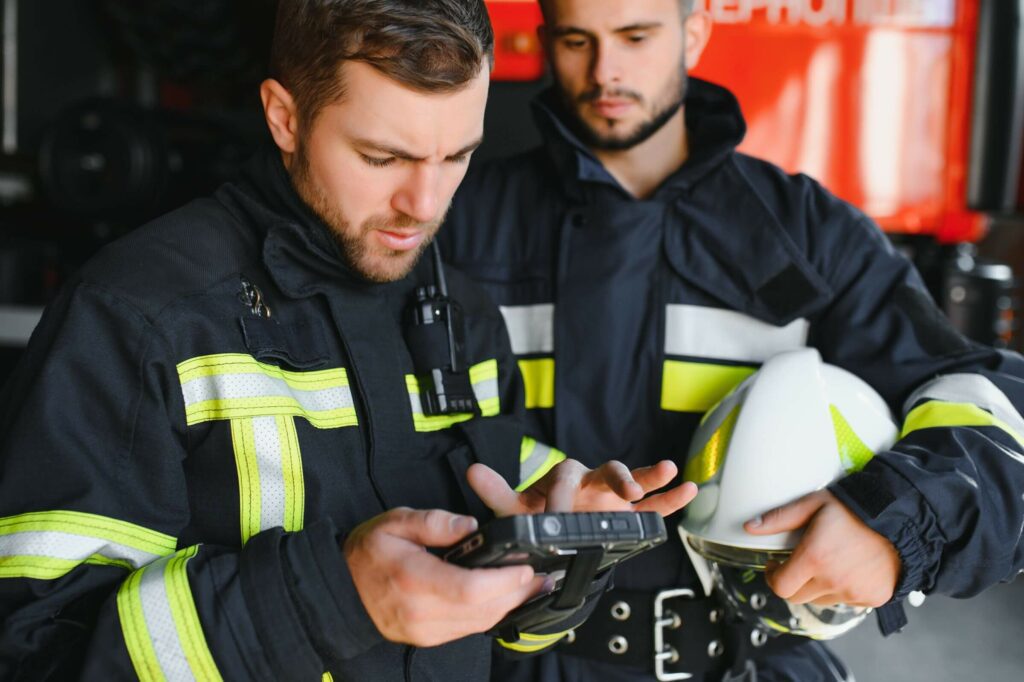 Firefighters looking at their mobile devices