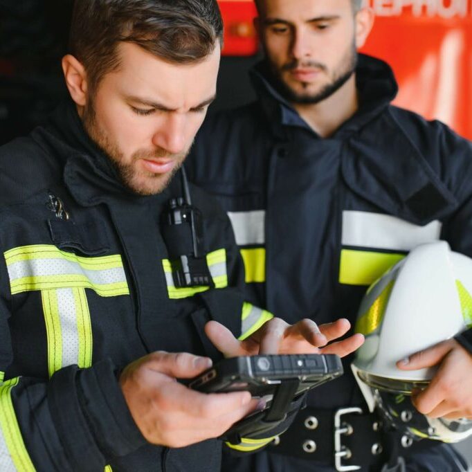 Firefighters looking at their mobile devices